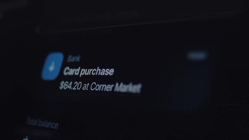 A close-up of a mobile banking app screen showing a push notification for a recent card purchase