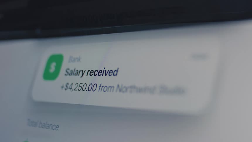 A digital banking app displays a pop-up notification confirming a salary deposit