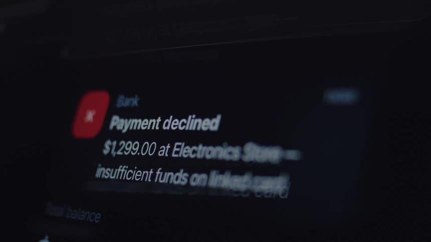 A shaky, close-up shot of a digital screen showing a "Payment Declined" notification for insufficient funds, with a glitch effect
