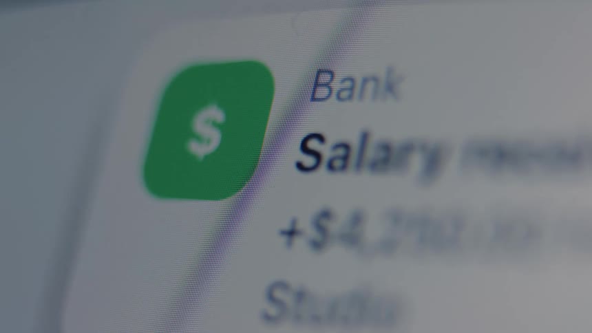 Macro shot of a banking application on a screen showing a salary deposit notification