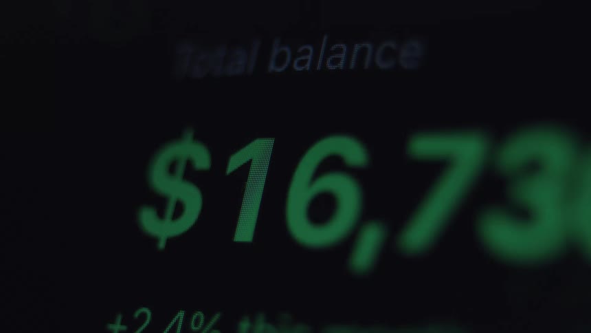 A financial investment account balance rapidly increasing on a dark digital display