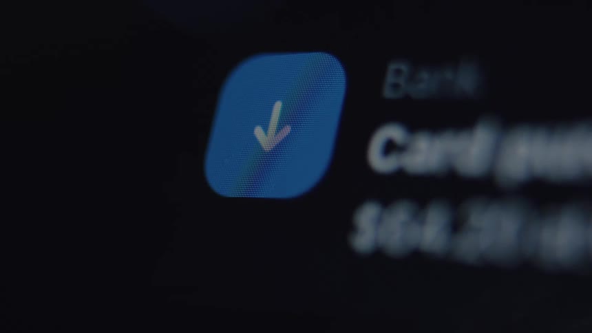 An extreme close-up shows a bank transaction notification for a payment received on a smartphone screen