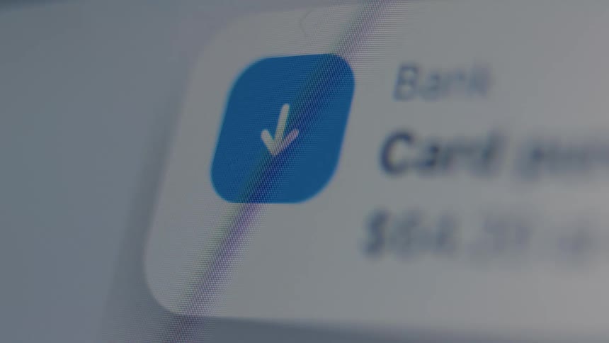 An extreme close-up of a digital screen displays a bank transaction notification message