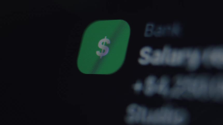 A close-up macro shot of a financial app showing a salary payment notification on a digital screen