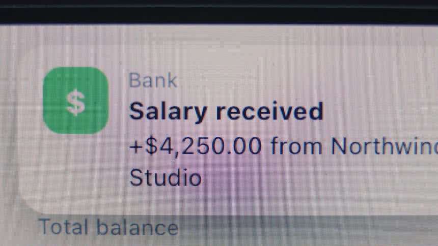 Close-up of a digital screen showing a salary payment notification of $4,250