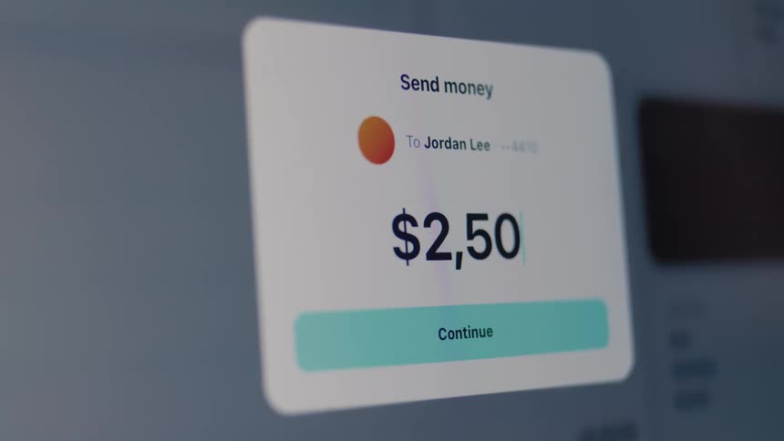 A close-up shot of a user sending $2,500 through a digital banking app on a computer screen