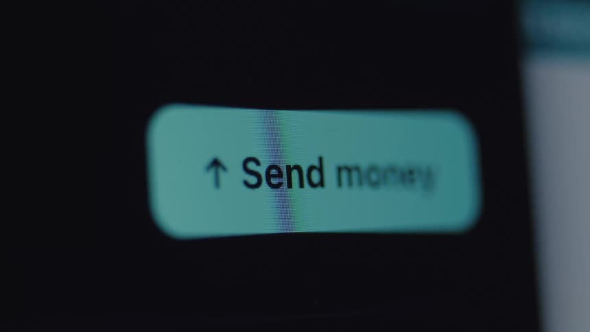 A macro close-up of a 'Send Money' button on a screen, symbolizing a digital financial transaction