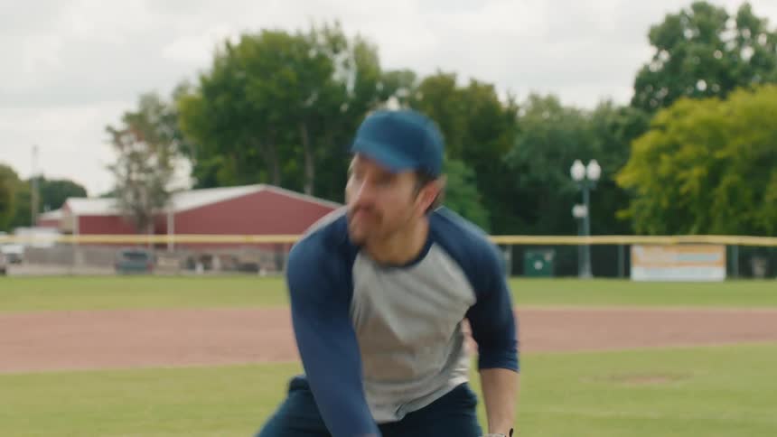 A frustrated baseball player throws a pitch and reacts to missing the catch in slow motion