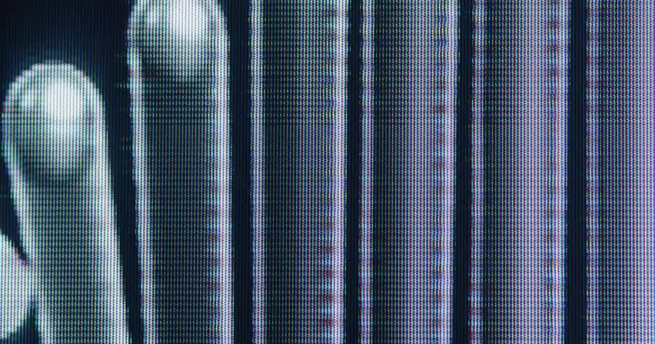 Extreme close-up of a finger swiping across a malfunctioning digital screen, showing pixels, glitches, and abstract shapes
