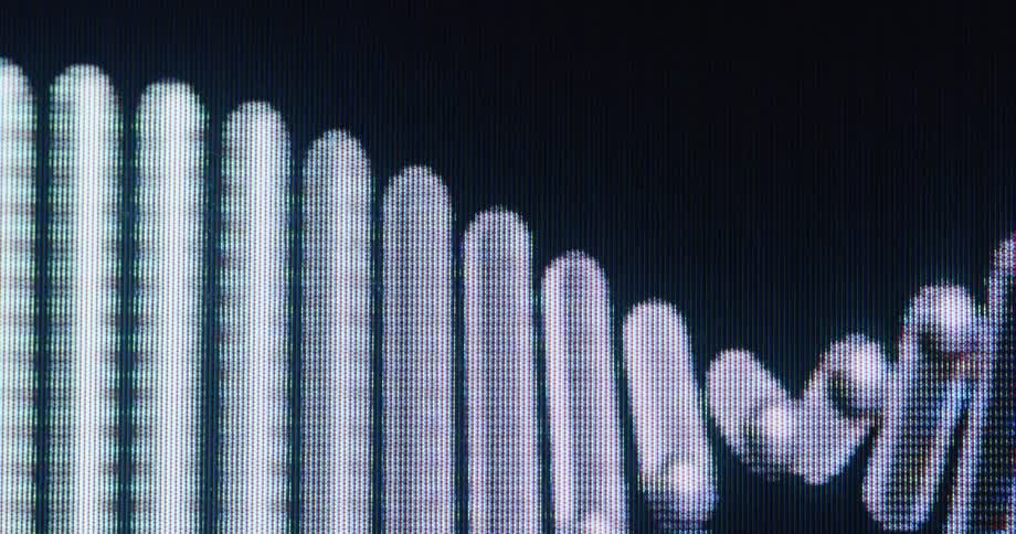 A macro shot of a pixelated audio waveform equalizer dancing on a digital CRT screen