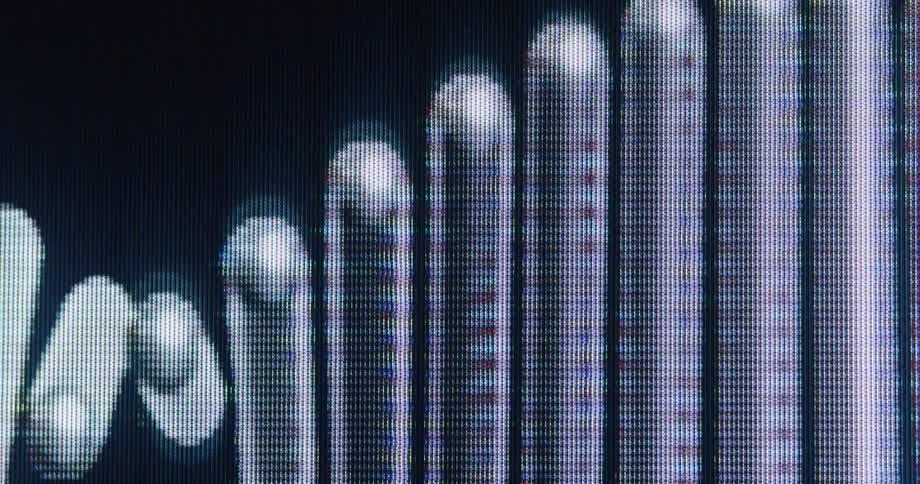 A close-up macro view of a digital audio visualizer with pixelated light bars moving on a screen