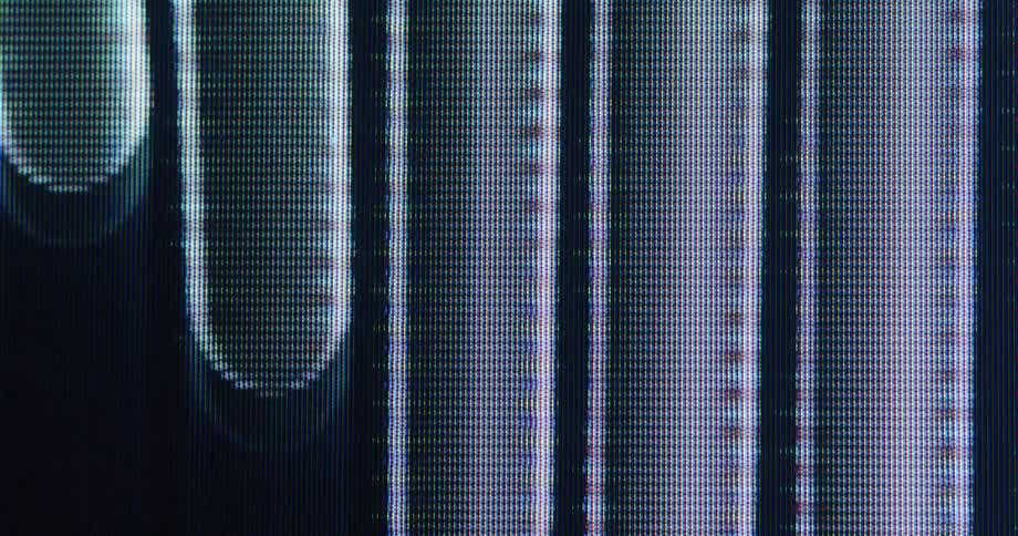 Macro view of pixelated abstract shapes and vertical bars glitching and distorting on a digital screen