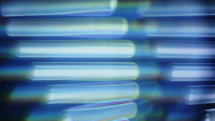 A mesmerizing loop of glowing blue digital DNA strands rotating with a prismatic lens effect