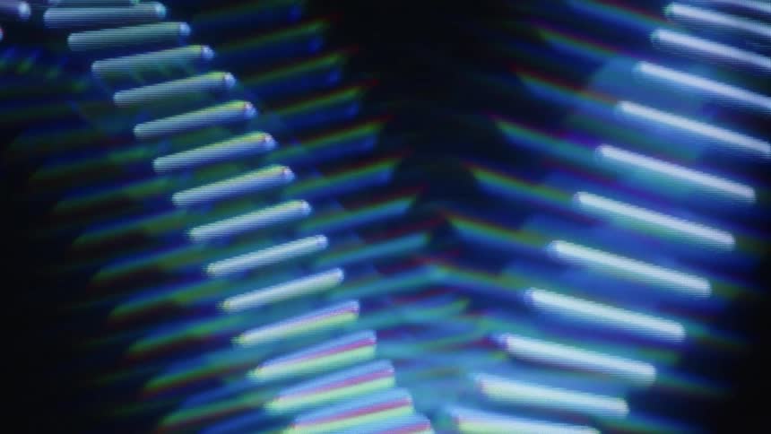 A hypnotic, seamless loop of abstract chevron light patterns with a blue prismatic glow against a dark background