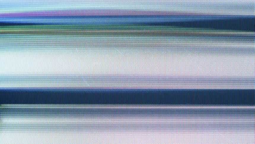 An abstract macro view of scrolling digital light bars reveals the individual RGB pixels of a computer screen