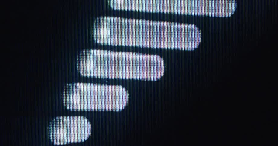 A macro view of abstract white digital bars pulsing and moving on a dark, pixellated screen