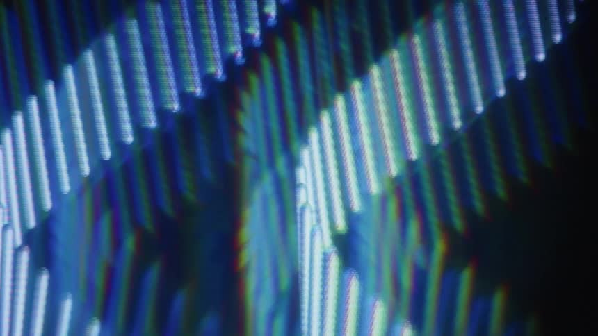 A close-up, abstract shot of blue light patterns undulating slowly with a prism effect