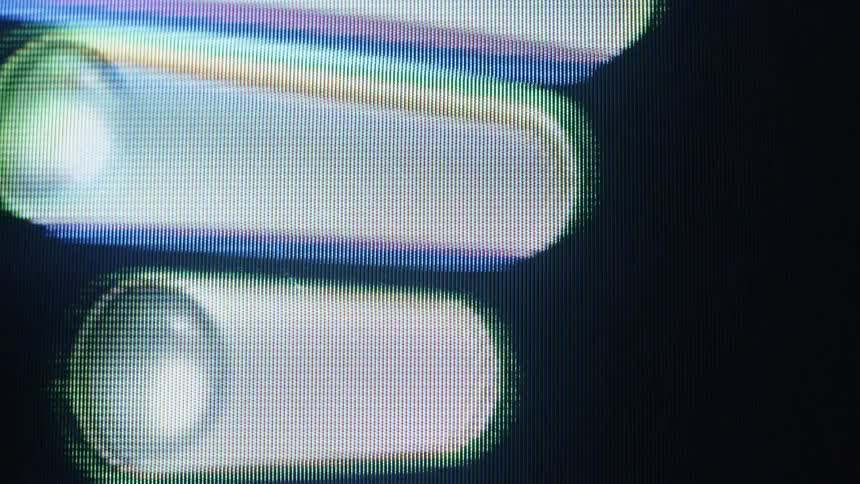 Abstract glowing bars of light distort and move across a pixelated screen in a macro view