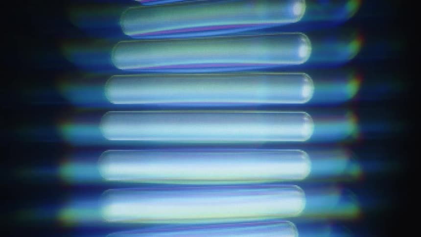 A close-up of a blue, glowing, digital DNA strand rotating on a continuous loop against a dark background