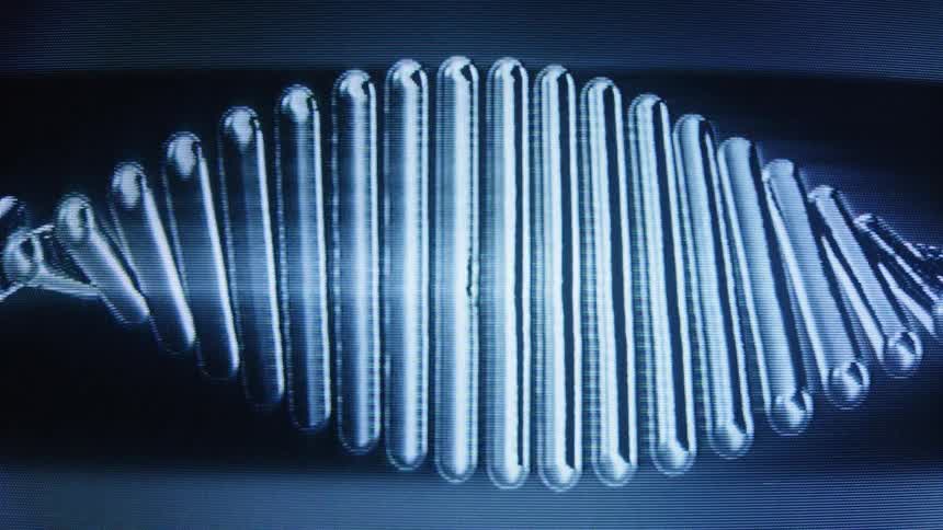 A digitally rendered DNA double helix in blue and silver tones rotates slowly in a seamless loop on a dark background