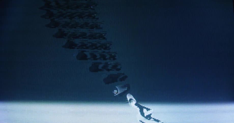 Close-up of a CRT screen showing a heavily distorted and glitchy animation of a spinning DNA strand