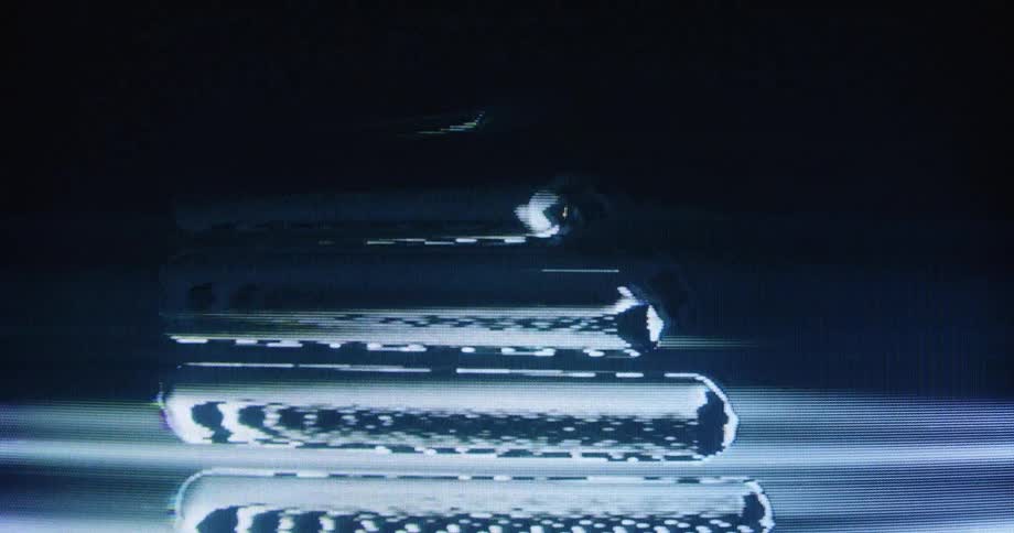 Close-up of a screen displaying distorted analog video signal with flickering rolling bars and glitch effects