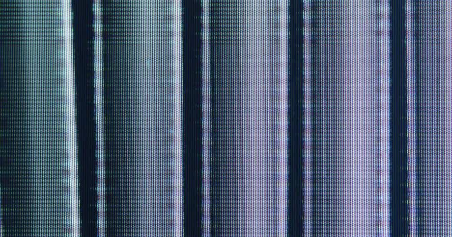 An abstract animation of a hand and vertical bars plays on a digital screen, creating a glitchy, pixelated visual effect