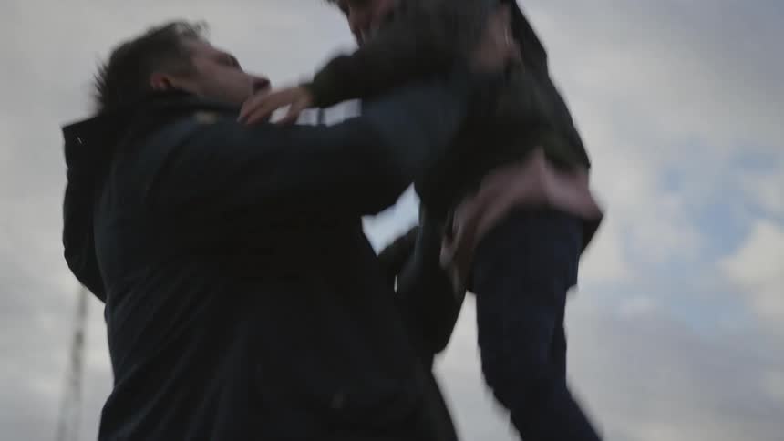 A happy boy runs gleefully into his father's arms, who lifts him high into the sky in a heartwarming slow-motion embrace