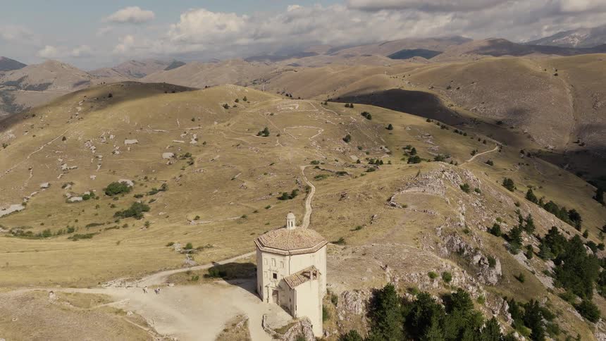 Epic aerial footage flies over the ancient Rocca Calascio castle and Santa Maria della Pietà church in the Italian Apennine Mountains
