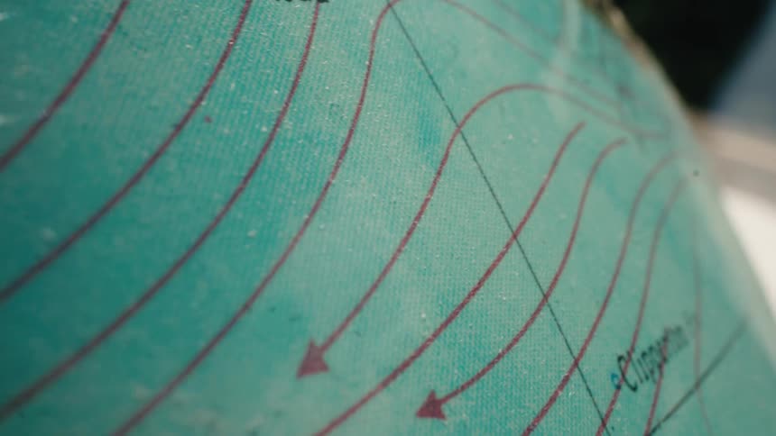 A macro slow pan across a vintage globe reveals the Pacific Ocean currents off the coast of Mexico