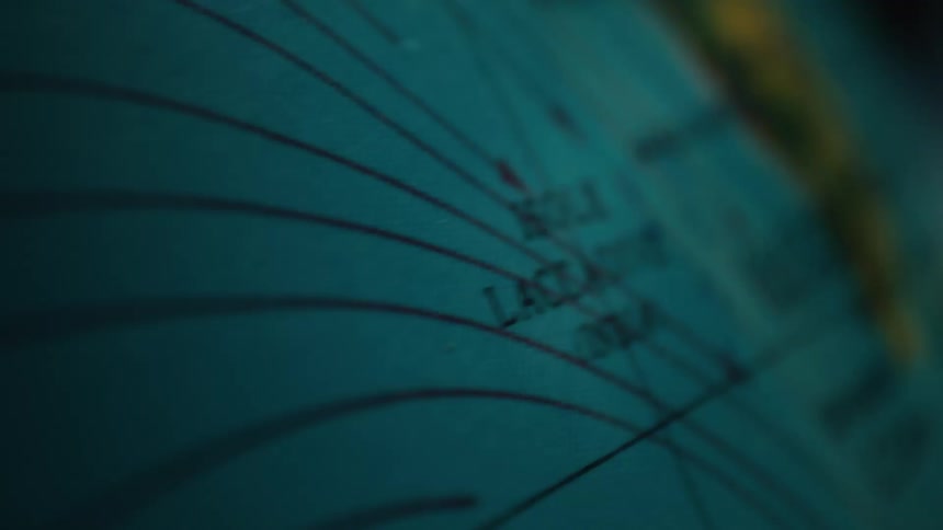 A macro shot of a vintage globe spinning slowly, with the focus shifting across the Indian subcontinent and the Arabian Peninsula