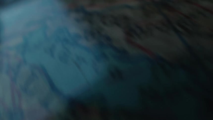 A macro shot of a vintage globe spinning and revealing various countries on an old world map
