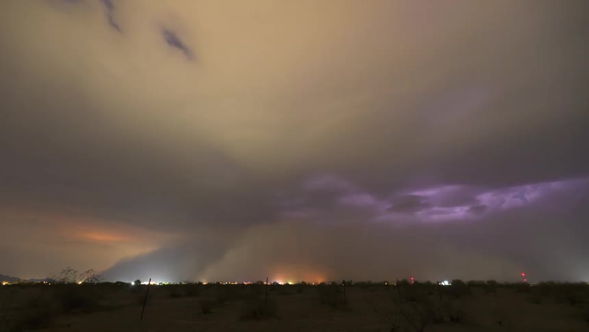 A dramatic nighttime timelapse shows a powerful haboob, or dust storm, with intense lightning as it completely engulfs a distant city