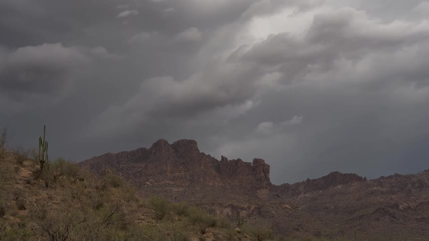 A dramatic time-lapse of dark storm clouds moving over the iconic Superstition Mountains in the Arizona desert