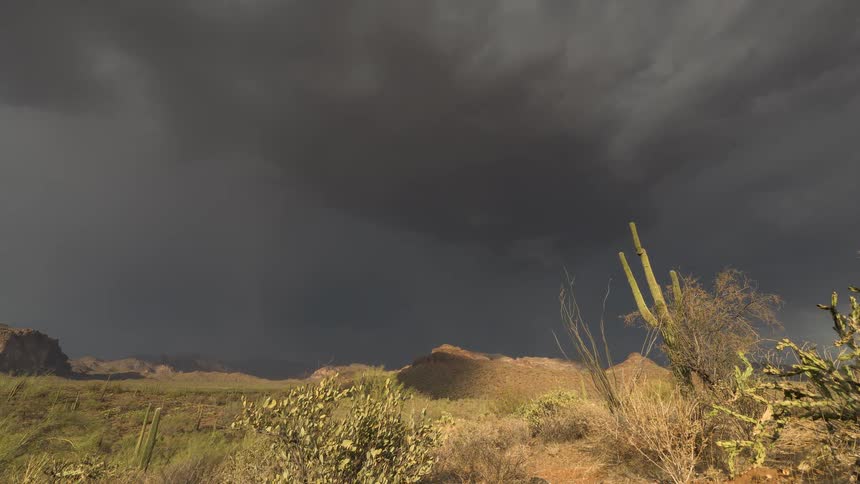 Dramatic time-lapse captures a powerful monsoon storm moving across the Arizona desert, revealing a rainbow as the clouds part and rain begins to fall