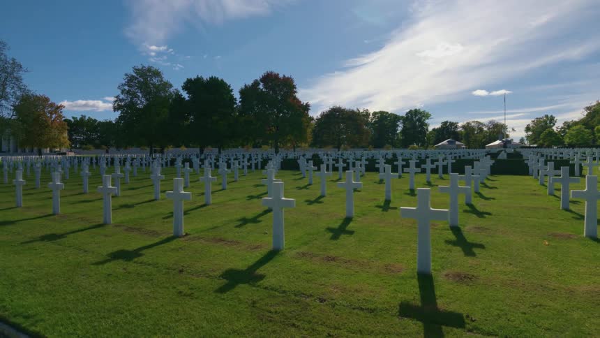 A time-lapse of shadows moving across the white crosses of a military cemetery on a sunny day