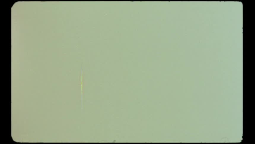 Aged film look with a yellow tint, flickering grain, and scratches inside a classic film frame