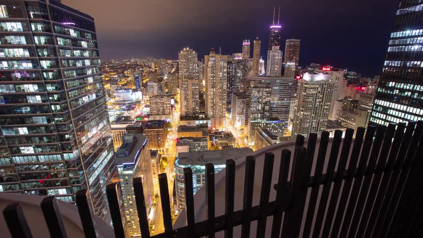 A stunning night time-lapse from a skyscraper overlooking the bustling streets and iconic skyline of downtown Chicago