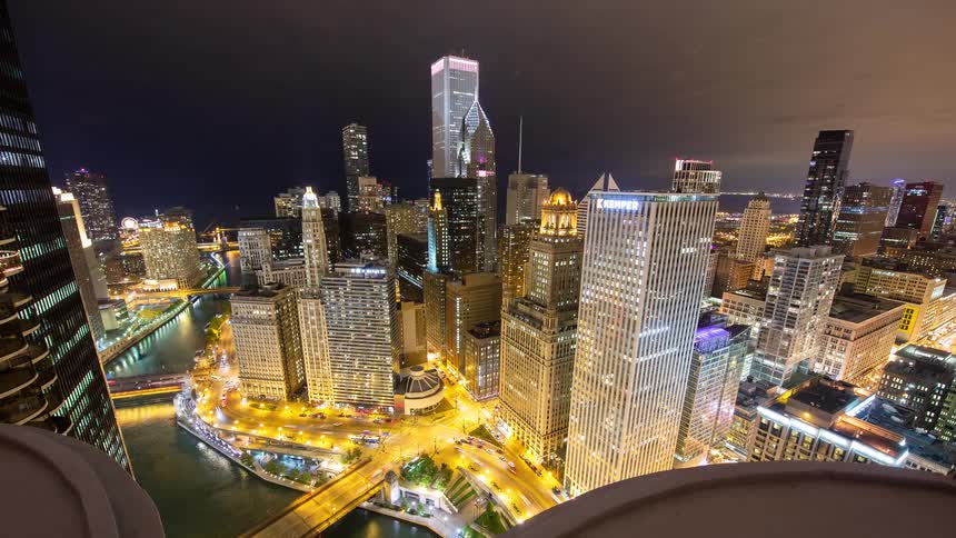 A stunning high-angle timelapse captures the vibrant energy of downtown Chicago at night, with traffic flowing along the river and bridges
