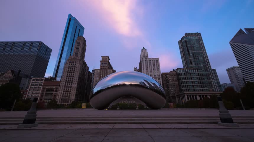 From dusk to dawn, a stunning timelapse captures a vibrant sunrise over the iconic 'Cloud Gate' sculpture in Chicago's Millennium Park