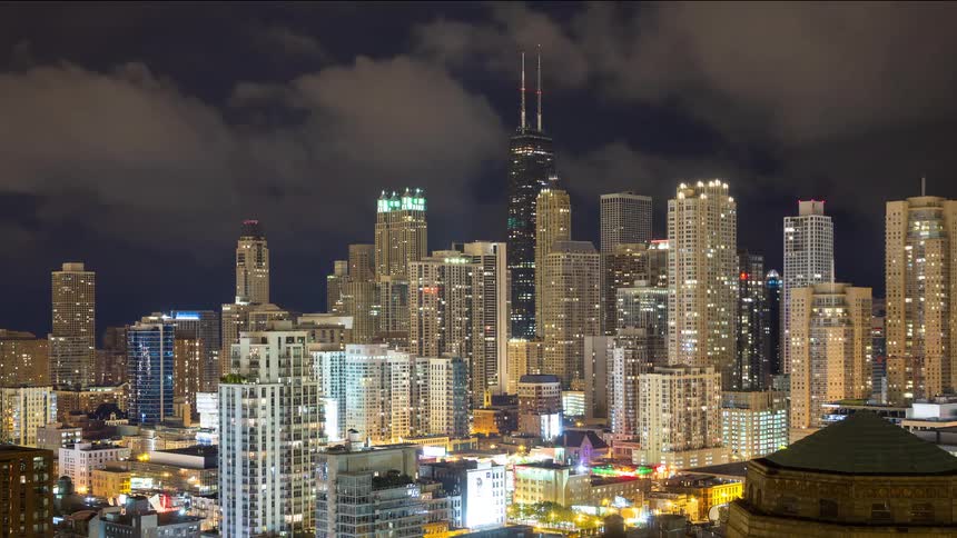 A time-lapse of the Chicago skyline at night shows clouds rolling over the brightly lit skyscrapers