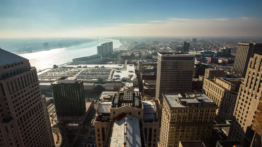 A sunny day time-lapse from a high angle shows shadows moving across downtown New Orleans and the Mississippi River