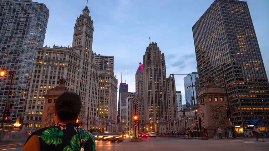 Day to night time-lapse captures the bustling traffic and iconic architecture of Michigan Avenue in downtown Chicago