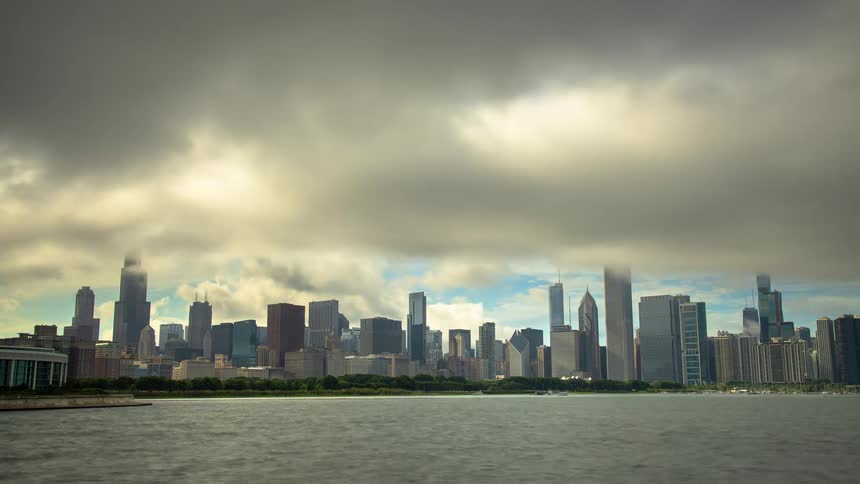 Dramatic timelapse of dense morning fog and clouds lifting to reveal the iconic Chicago skyline across Lake Michigan