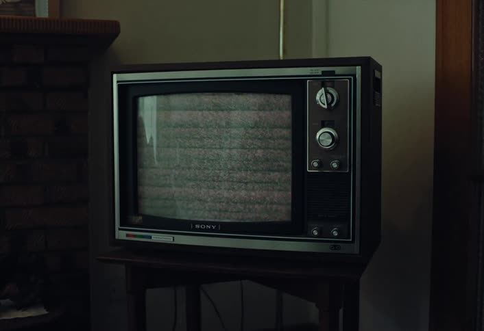 Static flickers on the screen of an old retro television set