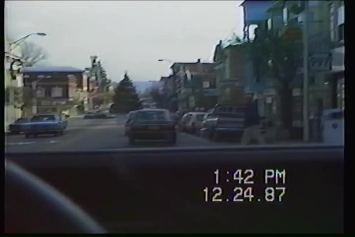 Vintage 1987 VHS footage captures a slow drive down the main street of a small American town on Christmas Eve