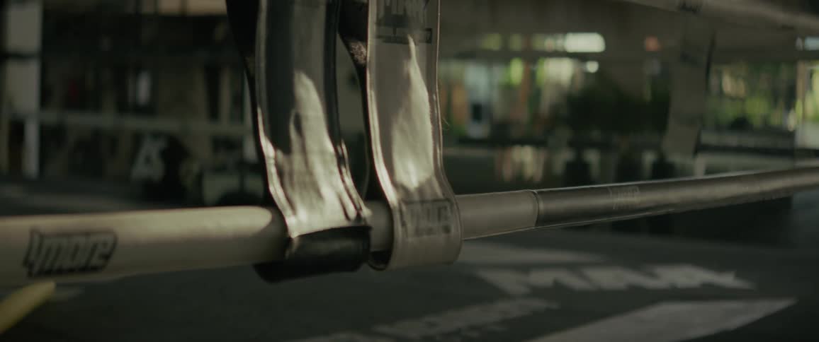 A cinematic close-up of the ropes in an empty MMA fighting ring