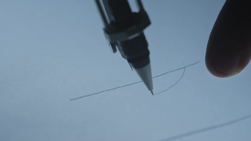 A close-up shot of a hand using a drawing compass to carefully draw a precise arc on a sheet of white paper