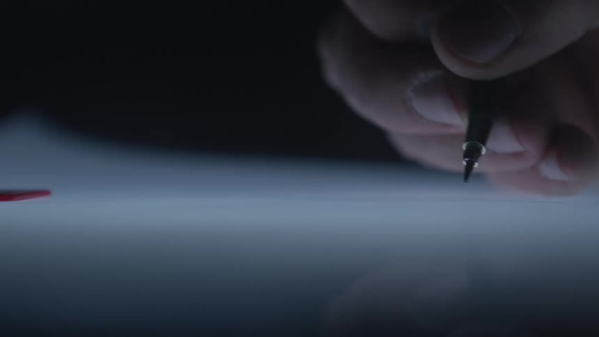 An extreme close-up of a hand meticulously drawing a straight line with a mechanical pencil on a glowing, backlit surface