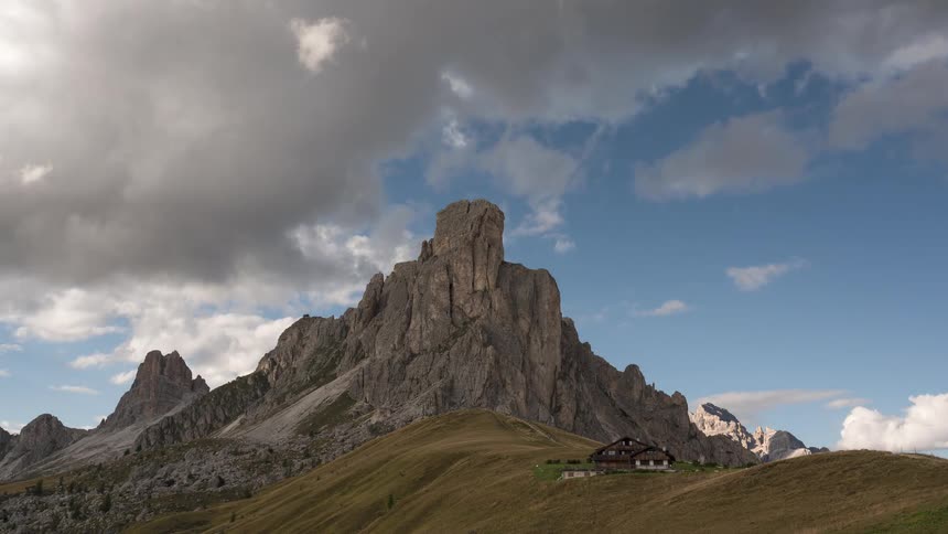 Dramatic timelapse clouds sweep across the sky above the iconic Ra Gusela mountain peak in the Italian Dolomites